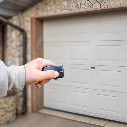 Lima security key fob pointing to a garage door